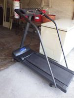 Weslo Cadence 860 treadmill showing angled side and control panel on the left side near a freezer and ladder.