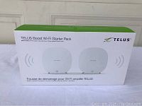 Front view of the TELUS Boost Wi-Fi Starter Pack box showing the two white Wi-Fi boosters included in the kit.