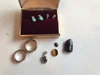Lot of sterling silver jewelry including two rings, earrings with opal and clear stones, vintage pendant with colored stones and polished loose stones including amethyst and tiger's eye.