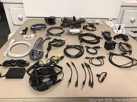 View of all cables, adapters, and headphones laid out on flat surface