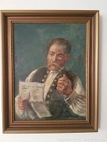 Framed antique oil painting showing a man holding a newspaper and pipe.