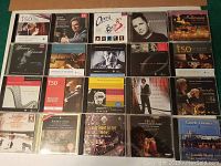 Photo showing full collection of 20 classical music CDs laid out on a surface, featuring various artists and orchestras.