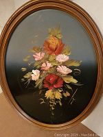 Full view of the antique oval floral oil painting framed in wooden oval frame showing the floral arrangement and the frame condition