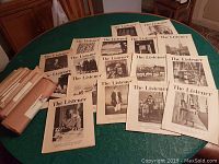 Collection of 18 issues of The Listener arranged on table showing front covers with black and white images and headlines.