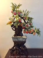 Full front view of the large vintage Chinese jade-style hard stone peach tree sculpture in pot and stand.
