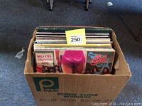 Box of vinyl records with visible albums Wild-Eyed Southern Boys by 38 Special and 38 Special album with pink shorts on cover.