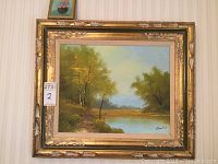 Framed large oil on canvas landscape painting depicting foliage and water, signed at bottom right.