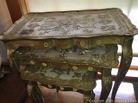 Set of three gold painted Italian nesting tables stacked with ornate carved legs visible, showing overall design and condition.