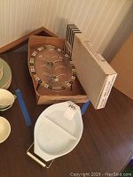 Photo showing rectangular glass platter with black and white geometric border and Fire-King oval platter