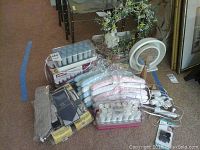 Full lot showing Remington hot rollers, Conair curling iron, lighted zoom mirror, padded hangers in blue and pink, and clear plastic hangers.