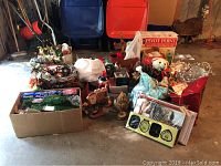 Overview of all holiday decorations in assorted boxes and bags, showing various ornaments, garlands, figures, and wreaths.