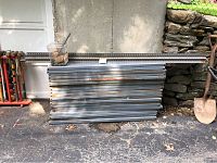 Multiple stacked metal shelves and vertical support posts showing condition and size