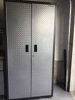 Closed front view of Gladiator cabinet showing diamond plate doors and overall condition