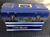 Closed blue and gray Mastercraft Maximum toolbox with yellow handle and metal latches, showing front view with drawers slightly open.
