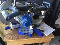 Kobalt 10" sliding compound miter saw mounted on wooden stand