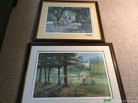 Two framed James Lumbers prints stacked, showing a carriage scene top and a golf scene bottom.