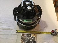 Cooklite Aero Fryer air fryer unit with measuring tape laid out showing size and slight usage label visible on front.