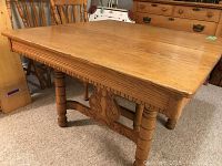 Full-angle view of oak dining table showing top surface and legs
