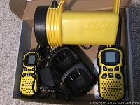 Motorola 2-way radios with chargers and power cords inside a cardboard box
