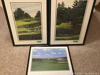 Three framed golf prints displayed on floor: two vertical limited edition Alan Kingsland prints and one horizontal Golfer's Prayer print.