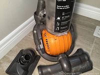Vacuum base on orange ball and two attachments on floor