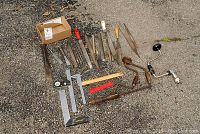 Overview of assorted hand tools laid out including chisels, files, measuring tools, and two manual hand drills