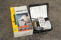 Wagner Power Painter 255 Kit outside box and open hard case showing hoses, spray gun, paint container, and manuals.