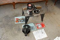 Photo of Craftsman Sears Super Router on a small work bench with manuals and router base on the floor.