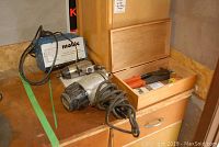 Photo of two electric impact wrenches and Mobie Auto Gel battery charger on wooden surface.