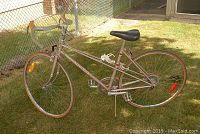 Full side view of Road King road bike showing frame, wheels, handlebar, seat, and pedals on grass background.