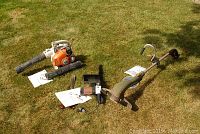 Remington electric chainsaw, McCulloch gas string trimmer, Stihl gas blower, and manuals pictured on grass