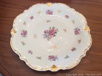 Top view of the vintage porcelain serving platter showing floral designs and gold accented scalloped edges.