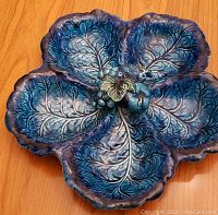 Top-down view of vintage 5 section ceramic serving dish, blue and green leaf pattern with fruit cluster center