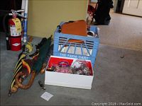 Photo showing umbrellas with wooden handles, vintage Boy Scout knife, and boxes with costume jewelry and purses