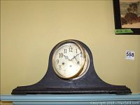 Front view of the vintage Seth Thomas wood mantel clock with visible clock face showing Arabic numerals and brass bezel.