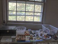 Overview of lot: jewelry box, crystal bowl, teacup and assorted jewelry pieces on table