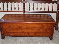 Front view of cedar blanket chest showing the closed top and wood grain with natural markings