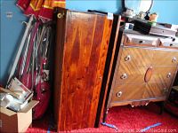 Full side view of the wooden cedar chest showing color and finish, with wheels at base visible.