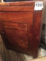 Side view of wood cabinet showing door and finish