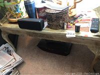Full top view of the rectangular side table with various items on top, showing its size and surface condition.