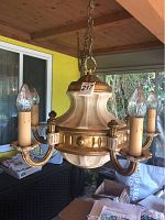 Vintage swag lamp hanging with five candle-style arms and bulbs, cream and gold finish