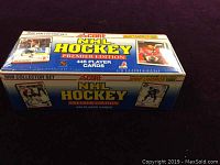 Box of 1990 Score NHL Hockey Premier Edition sealed collector set with 445 player cards, showing side and top views.