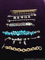 All nine bracelets arranged side by side on black velvet fabric, showing full length and detail of each bracelet