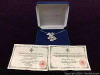Necklace, certificate of authenticity, and Camrose & Kross branded jewelry box.