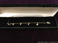 Full length of bracelet inside black velvet box