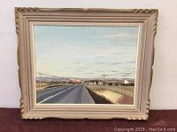 Full view of the framed oil painting showing the rural road and landscape scene with houses and mountains in the background.
