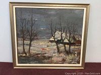 Framed oil on canvas winter landscape painting featuring leafless trees and houses under a cloudy sky.