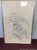 Full view of the framed ink drawing showing abstract linear composition with the artist signature and series notation visible.