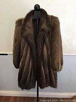 Full front view of the medium brown beaver fur coat on a mannequin.