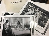 Close-up of several 8x10 glossy promotional photos from Forrest Gump, showing scenes with characters sitting on benches and in hospital rooms.